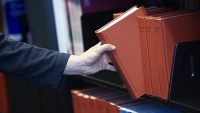 Book being taken from a library shelf